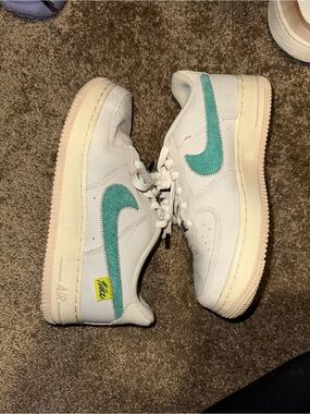 Nike Kids White Sneakers with Teal Swoosh and Yellow Tag